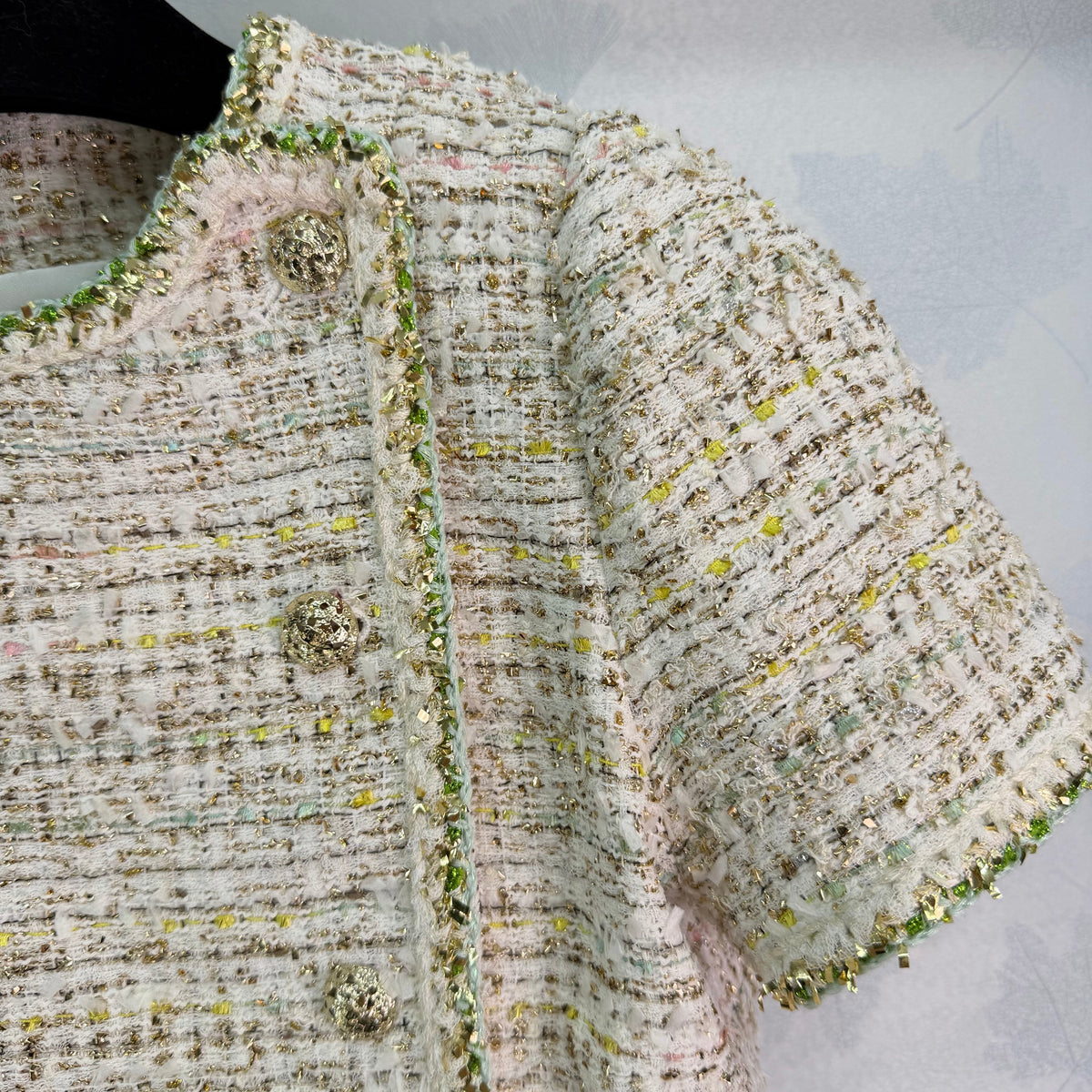 A light beige tweed blend short-sleeved jacket