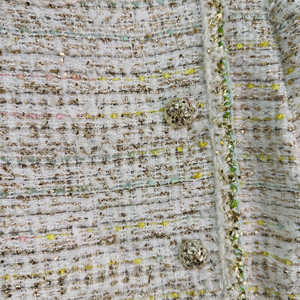 A light beige tweed blend short-sleeved jacket