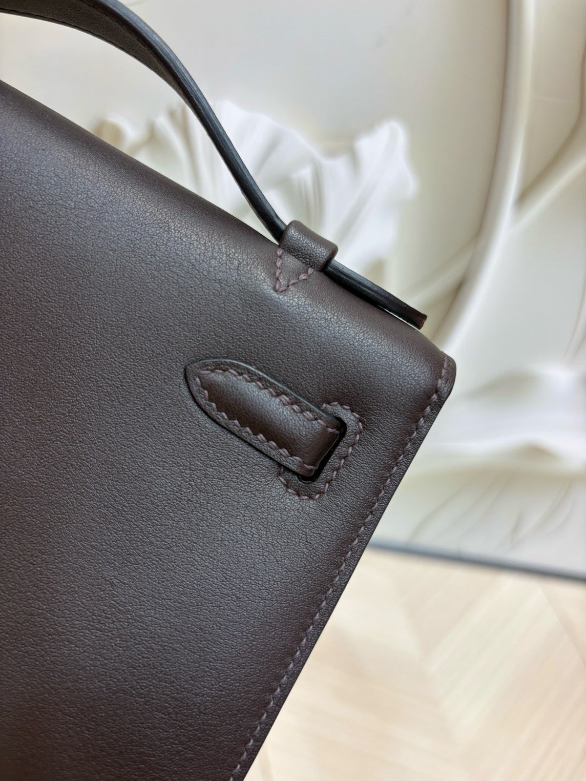 brown pochette with gold hardware
